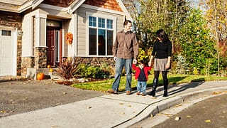 parents and child walking outside house lzHs.width .jpg