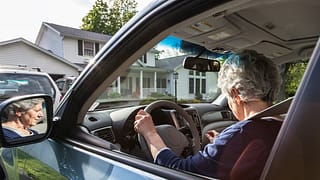 person driving car in front of house dLfSE.width .jpg