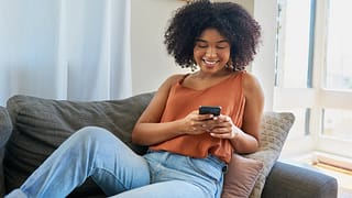 person on couch with phone TIHLN.width .jpg