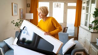 person unboxing new tv iIIanrE.width .jpg