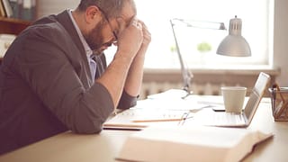 stressed man working at desk AnncGI.width .jpg