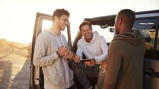 three men in car road trip.width .jpg