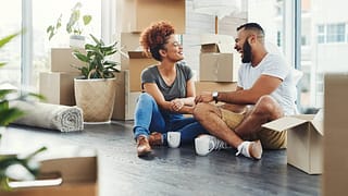 two people on floor between moving boxes kVBB.width .jpg