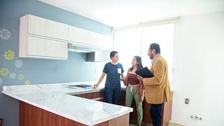 two people with realtor in kitchen XaHTHIU.width .jpg
