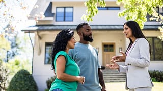 two people with realtor outside house KeFovDR.width .jpg