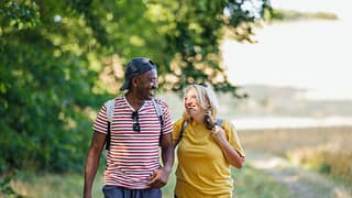 two smiling people hiking pHjfNub.width .jpg