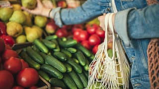 woman buying produce at grocery store.width .jpg