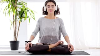woman doing yoga with headphones.width .jpg