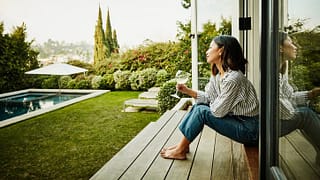 woman in backyard of house KrlPrb.width .jpg