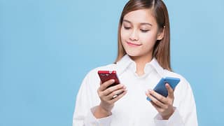 woman looking at red phone and blue phone.width .jpg