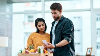 Couple looking unhappy with receipt for their.width aJabEC.jpg