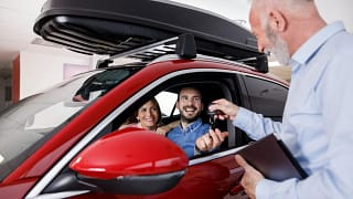 Couple receiving a new car keys from car sale.width PKhkAs.jpg
