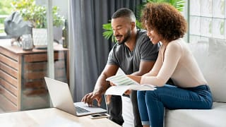 Couple sit and go over personal finances fTc.width .jpg