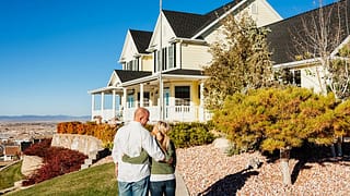 Couple standing outside admiring a large impr.width uPzLDk.jpg
