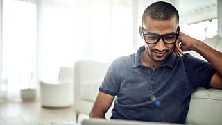 GuyWithGlassesLookingAtLaptop.width AAbSH.jpg