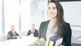 Happy businesswoman leaving job with box of b.width qZUZkS.jpg
