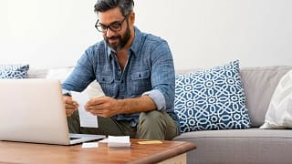 Man paying bills oNYYcl.width .jpg