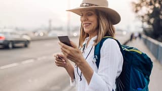 Mature woman holding her phone and a credit c.width UAbKy.jpg