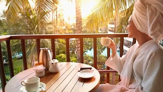 Woman in robe drinking coffee on balcony at t.width XIPpxO.jpg