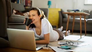 Woman pauses paying bills to enjoy coffee k.width .jpg