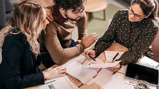 Young couple going over paperwork with female.width hAKGlR.jpg