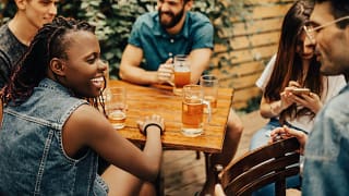 friends drinking beers at patio table WwKdweZ.width .jpg