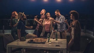 friends eating pizza and beer at rooftop part.width pMowu.jpg