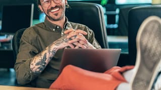 getty happy feet on desk smiling tattoos.jpg