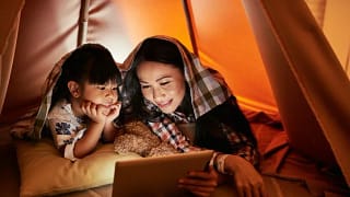 mom and young daughter watching movie on tabl.width .jpg