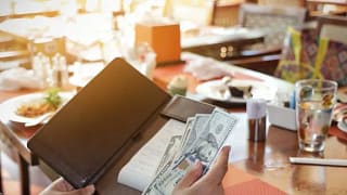 paying restaurant check with cash.width .jpg