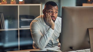 person sitting at a computer looking uncertain.jpg