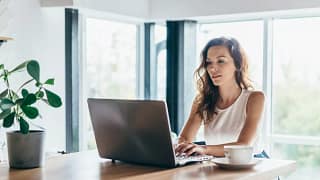 person on laptop at dining table aUpw.width .jpg