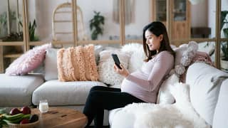 pregnant person on couch with phone GMwLu.width .jpg