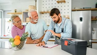 repairman talks to couple in kitchen KLkHSy.width .jpg