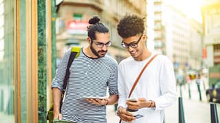 two men outside with phone and credit card Fh.width .jpg