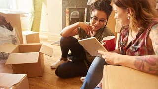 two women with moving boxes and tablet IrIKZ.width .jpg