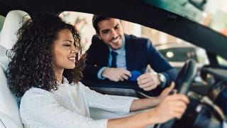 woman in car with salesman Geqvxx.width .jpg