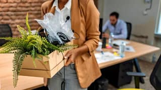 woman leaving office with box oXLGUKN uxkHRi.width .jpg
