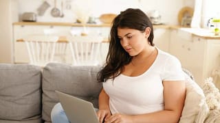 woman on couch with laptop.width .jpg
