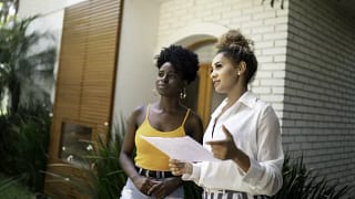 woman with realtor outside house.width .jpg