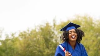 young smiling woman on graduation day wearing.width TjRKa.jpg