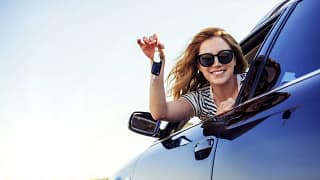 young woman leaning out of car window and hol.width maFaPm.jpg