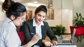 Bank employee and customer signing documents .width WrzFB.jpg