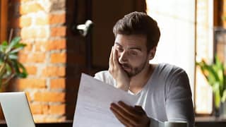 StressedOutGuyLookingAtPaper.width .jpg