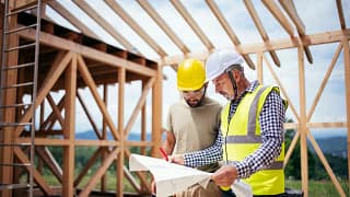 Two builders review blueprints inside an in p.width WEbpsh.jpg