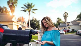 Woman checking mailbox in neighborhood with p.width WPxG.jpg