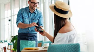Woman paying waiter credit card KqTSHc.width .jpg