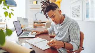 Young man looks over his investment accounts .width .jpg