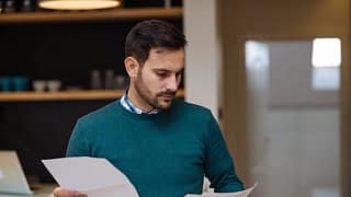man holding papers zXjSvlk.width .jpg