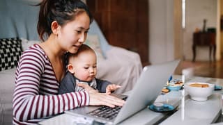 mom laptop holding baby gettyimages .jpg